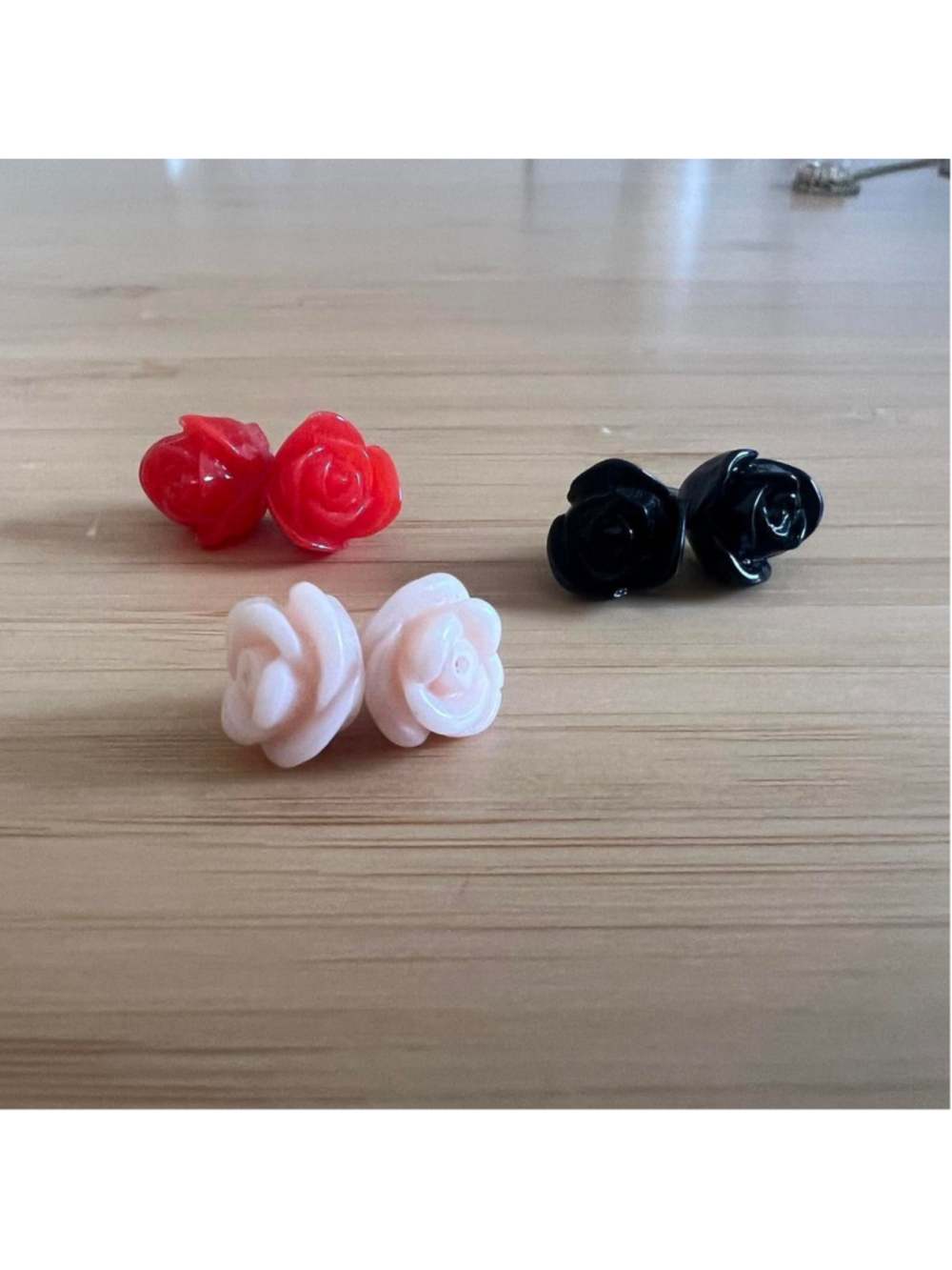 3 sets of rose stud earrings in various colors